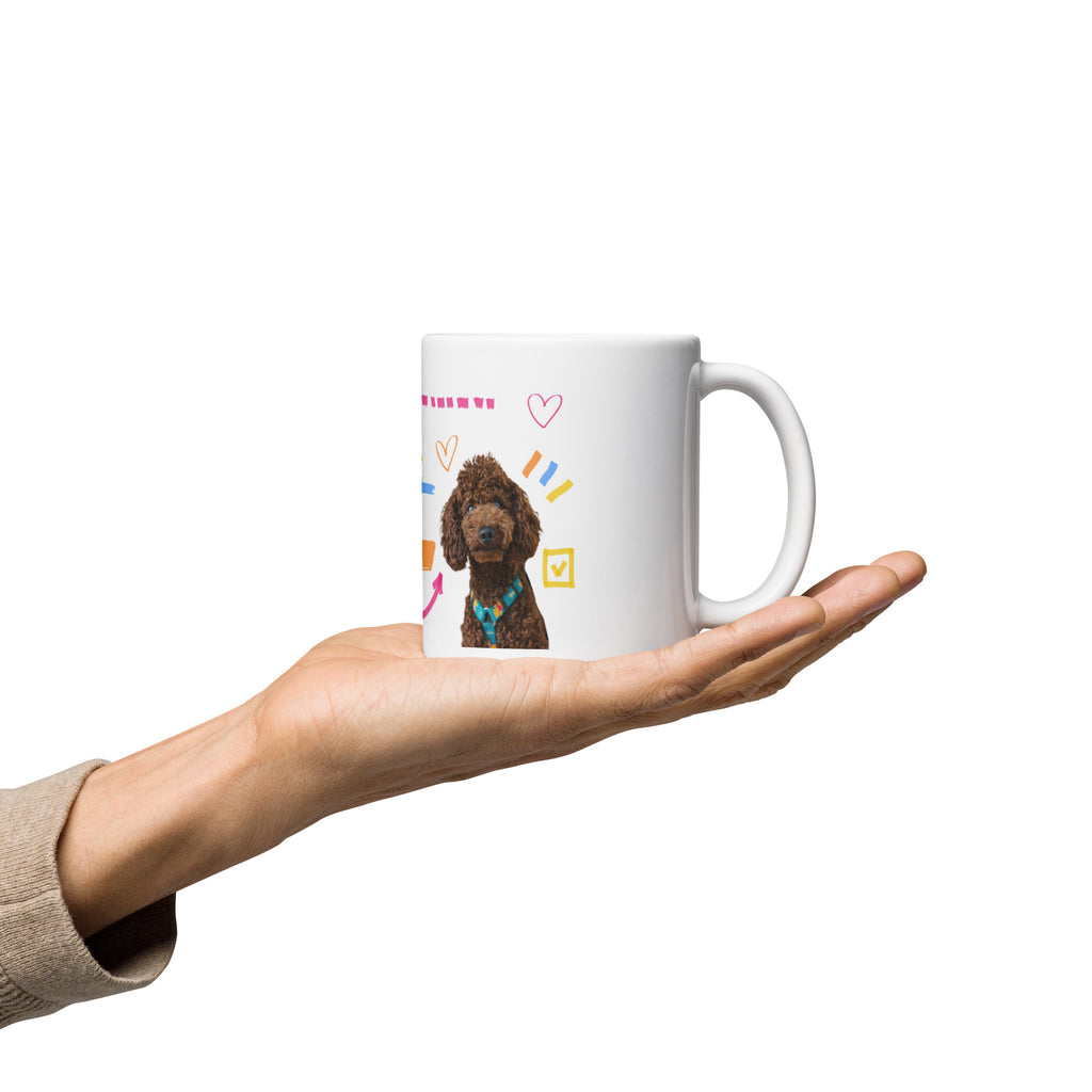 This custom white ceramic mug features an adorable brown poodle portrait surrounded by playful hand-drawn doodles, including hearts, checkmarks and colourful marker strokes.
Vibrant, whimsical decorations wrap around both sides of the cup, making it a sweet personalized gift for dog lovers.
Perfect for enjoying your morning coffee while showing off your love for your furry friend.