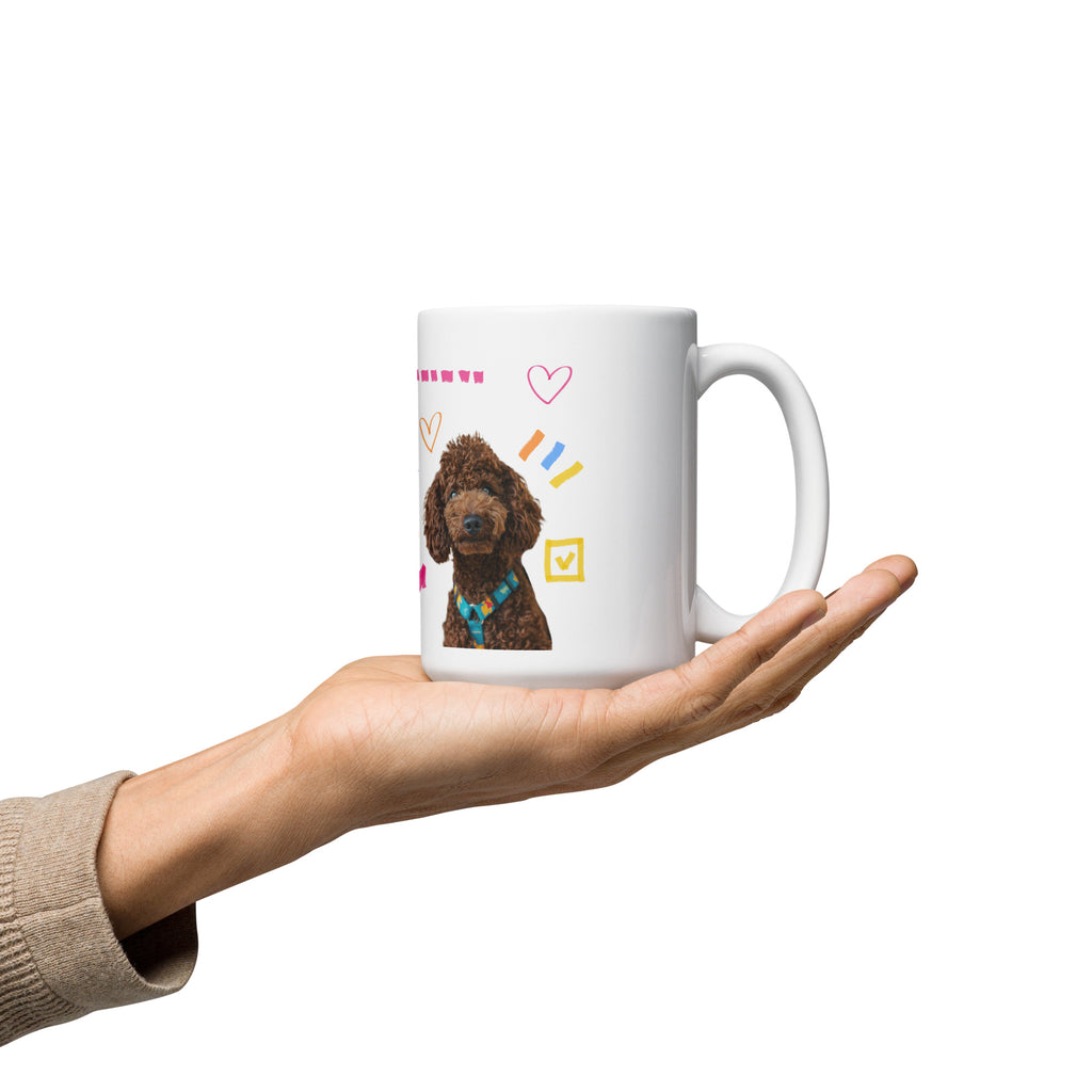 This custom white ceramic mug features an adorable brown poodle portrait surrounded by playful hand-drawn doodles, including hearts, checkmarks and colourful marker strokes.
Vibrant, whimsical decorations wrap around both sides of the cup, making it a sweet personalized gift for dog lovers.
Perfect for enjoying your morning coffee while showing off your love for your furry friend.