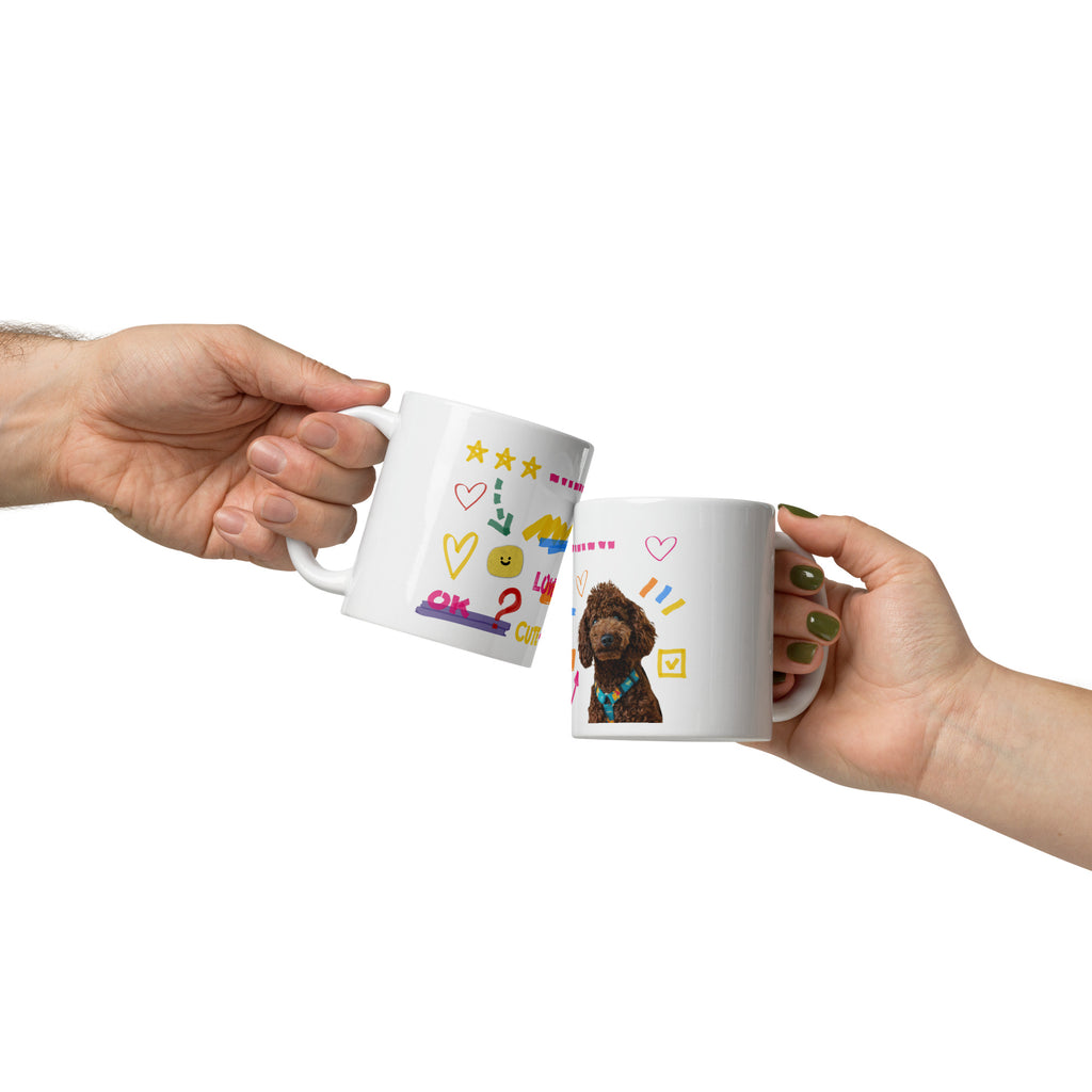 This custom white ceramic mug features an adorable brown poodle portrait surrounded by playful hand-drawn doodles, including hearts, checkmarks and colourful marker strokes.
Vibrant, whimsical decorations wrap around both sides of the cup, making it a sweet personalized gift for dog lovers.
Perfect for enjoying your morning coffee while showing off your love for your furry friend.