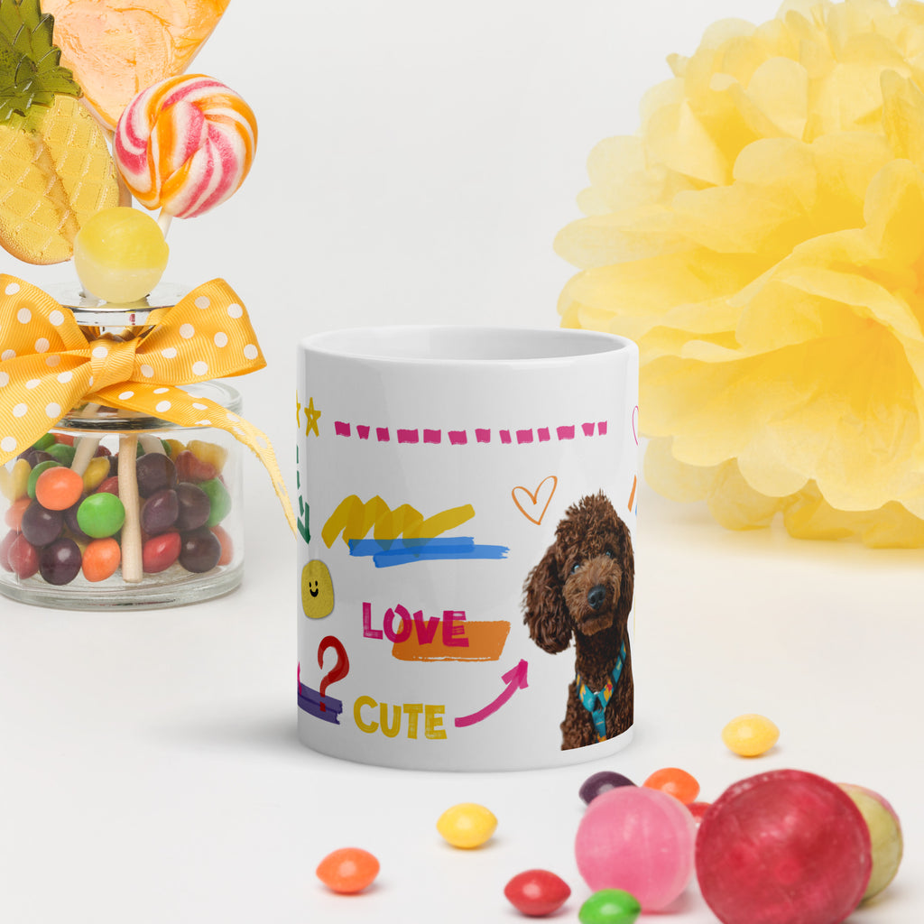 This custom white ceramic mug features an adorable brown poodle portrait surrounded by playful hand-drawn doodles, including hearts, checkmarks and colourful marker strokes.
Vibrant, whimsical decorations wrap around both sides of the cup, making it a sweet personalized gift for dog lovers.
Perfect for enjoying your morning coffee while showing off your love for your furry friend.