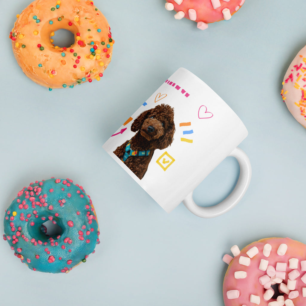 This custom white ceramic mug features an adorable brown poodle portrait surrounded by playful hand-drawn doodles, including hearts, checkmarks and colourful marker strokes.
Vibrant, whimsical decorations wrap around both sides of the cup, making it a sweet personalized gift for dog lovers.
Perfect for enjoying your morning coffee while showing off your love for your furry friend.